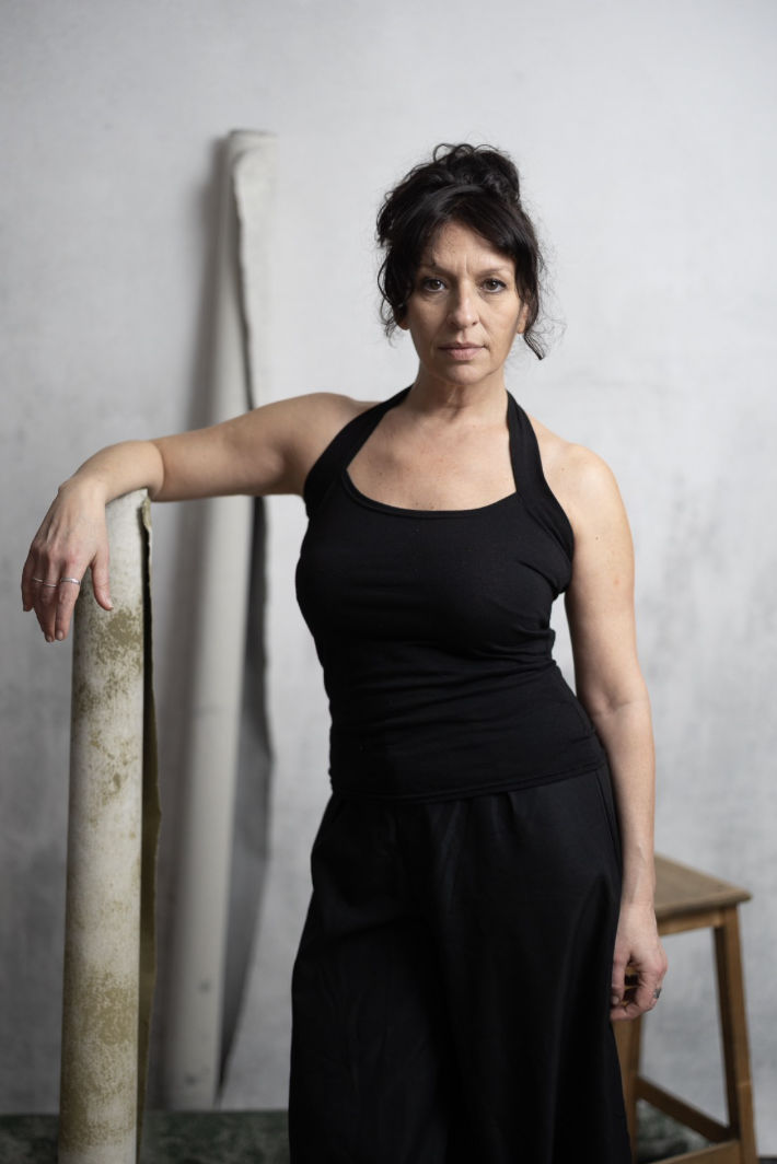 Oriane B, debout en studio, tenue noire